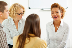 Four people comfortably talk and laugh in an open space